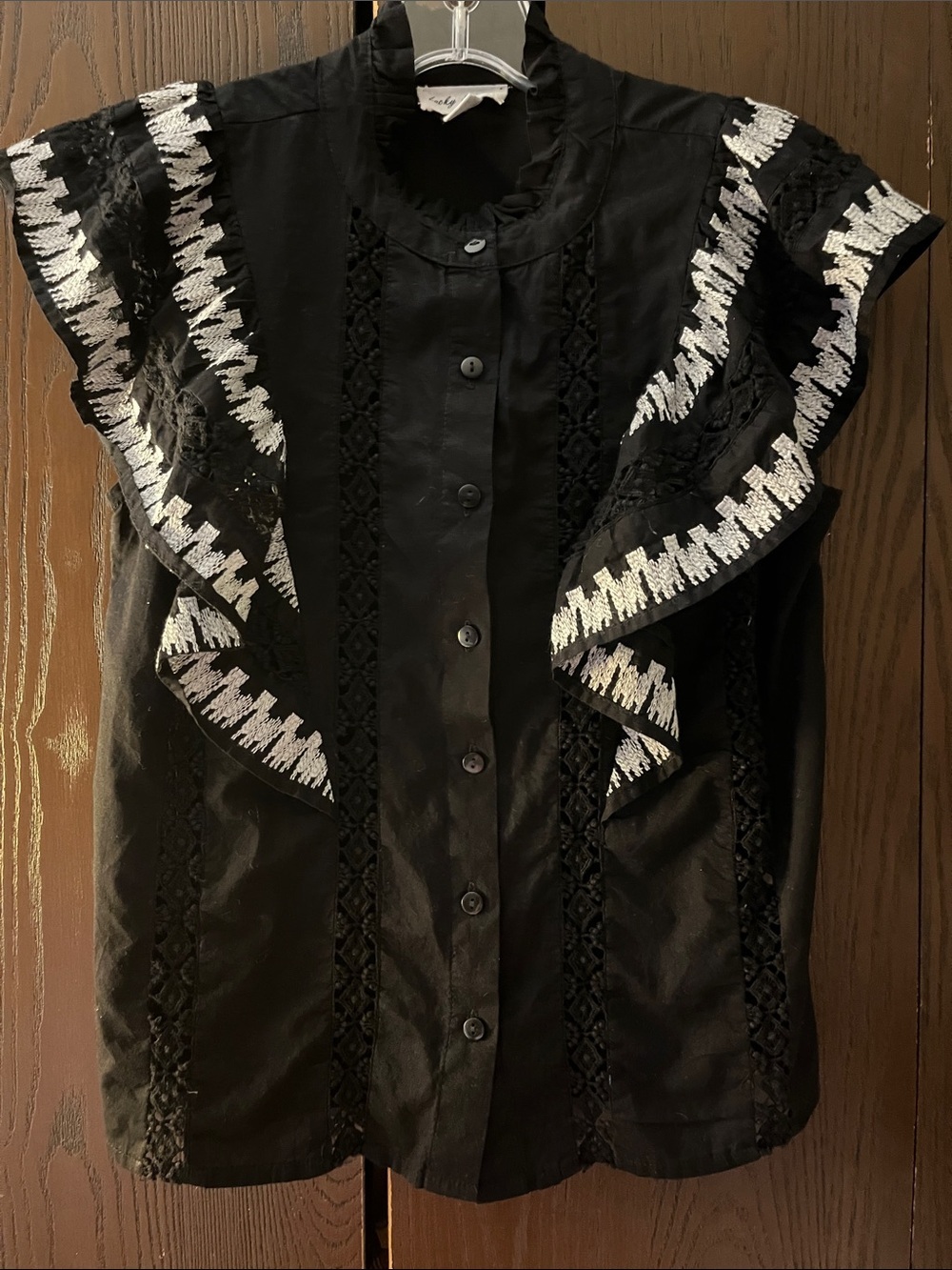 Lucky & Coco sleeveless black blouse with ruffles at the arms. Size Medium.